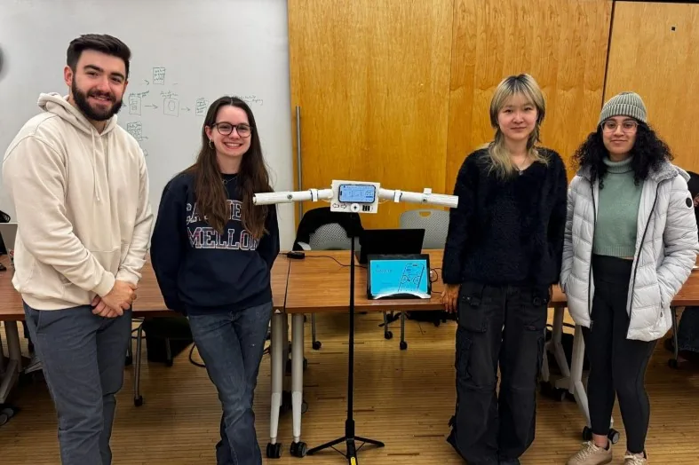 The team standing with the physical prototype of the ebike handles